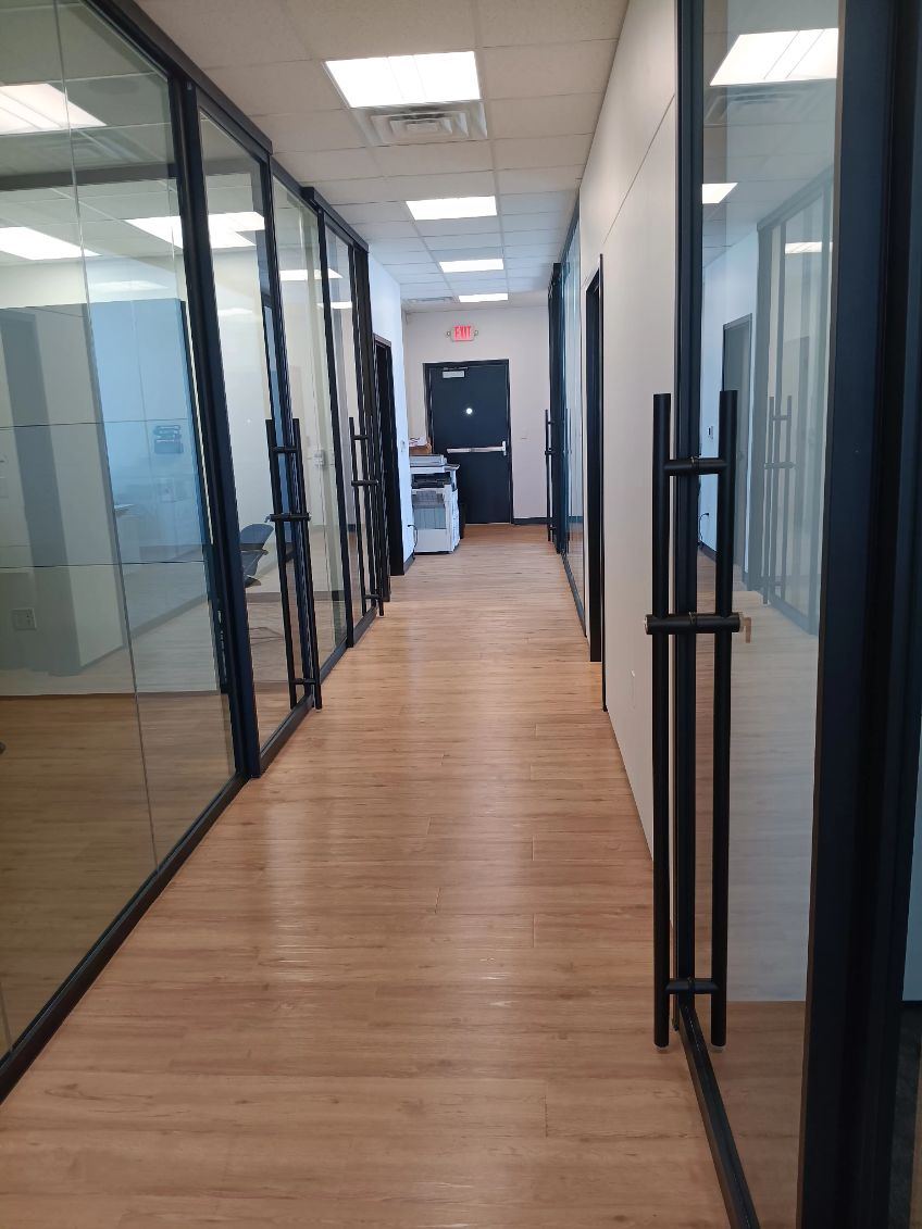 Clean office hallway with glass walls